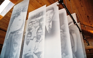 Larger-than-life faces materialize from the past on silk banners at the 2003 opening of the “Snow Country Prison” exhibit at United Tribes Technical College. (Dennis J. Neumann, UTTC Library/Archive digital collection)